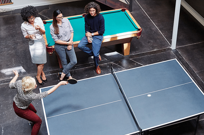 employees playing ping pong